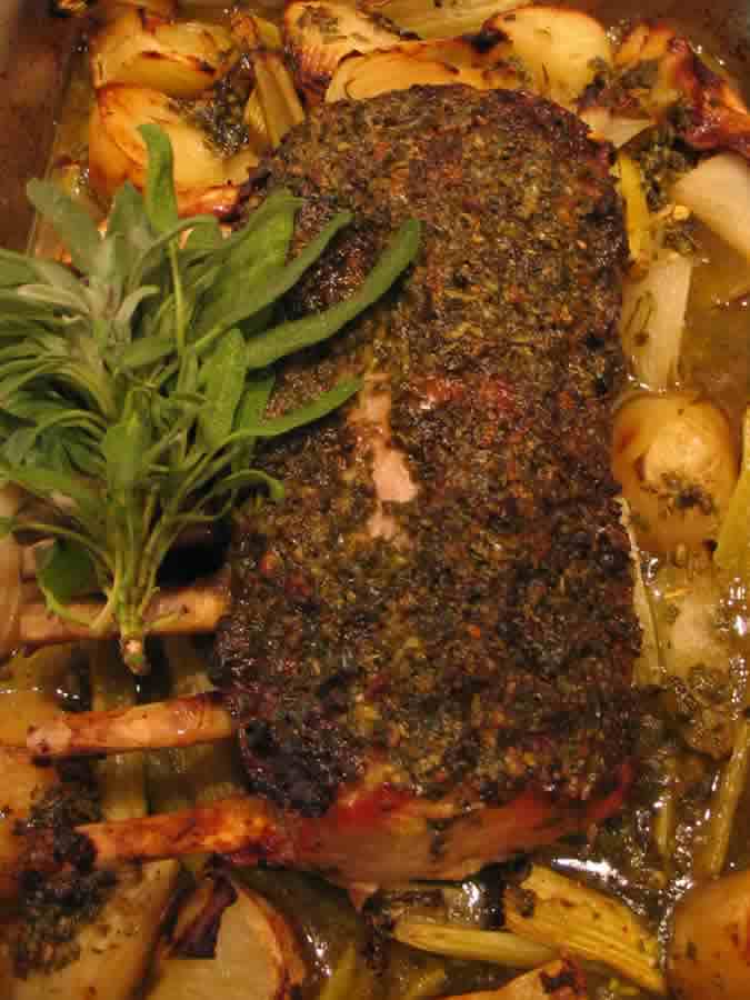 Pork Rack garnished with potatoes, sweet onions, and celery